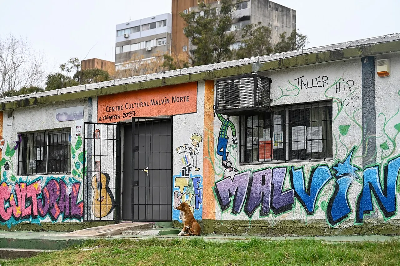 Fachada del Centro Cultural Malvín Norte, con mural de graffiti y el nombre del barrio pintado en la pared, sobre Hipólito Yrigoyen